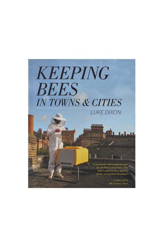 Book:  Keeping Bees in Towns & Cities with a beekeeper on a roof in a city on the cover..