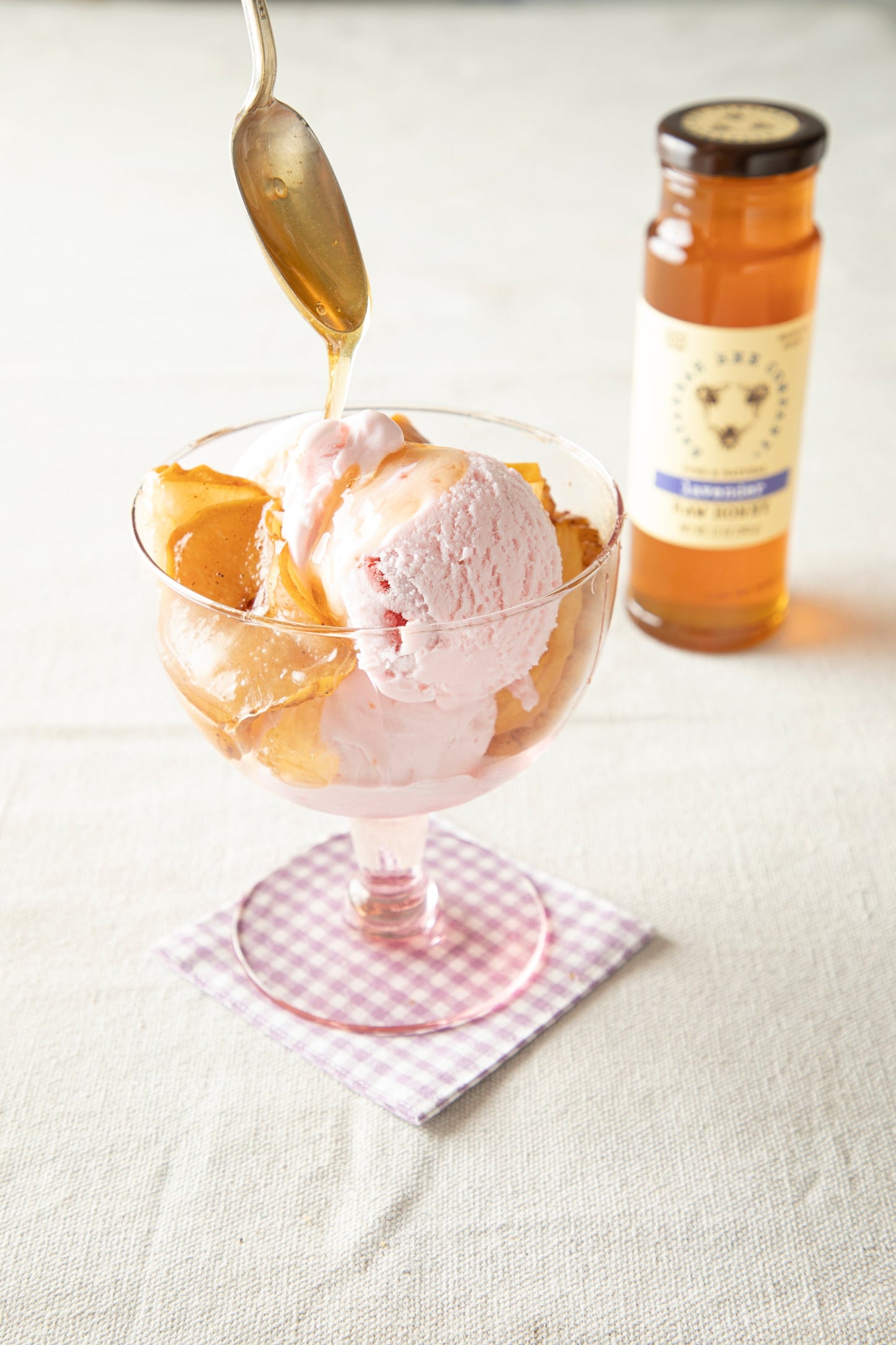 Sauteed Pears and ice dream being drizzled with Lavender Honey.