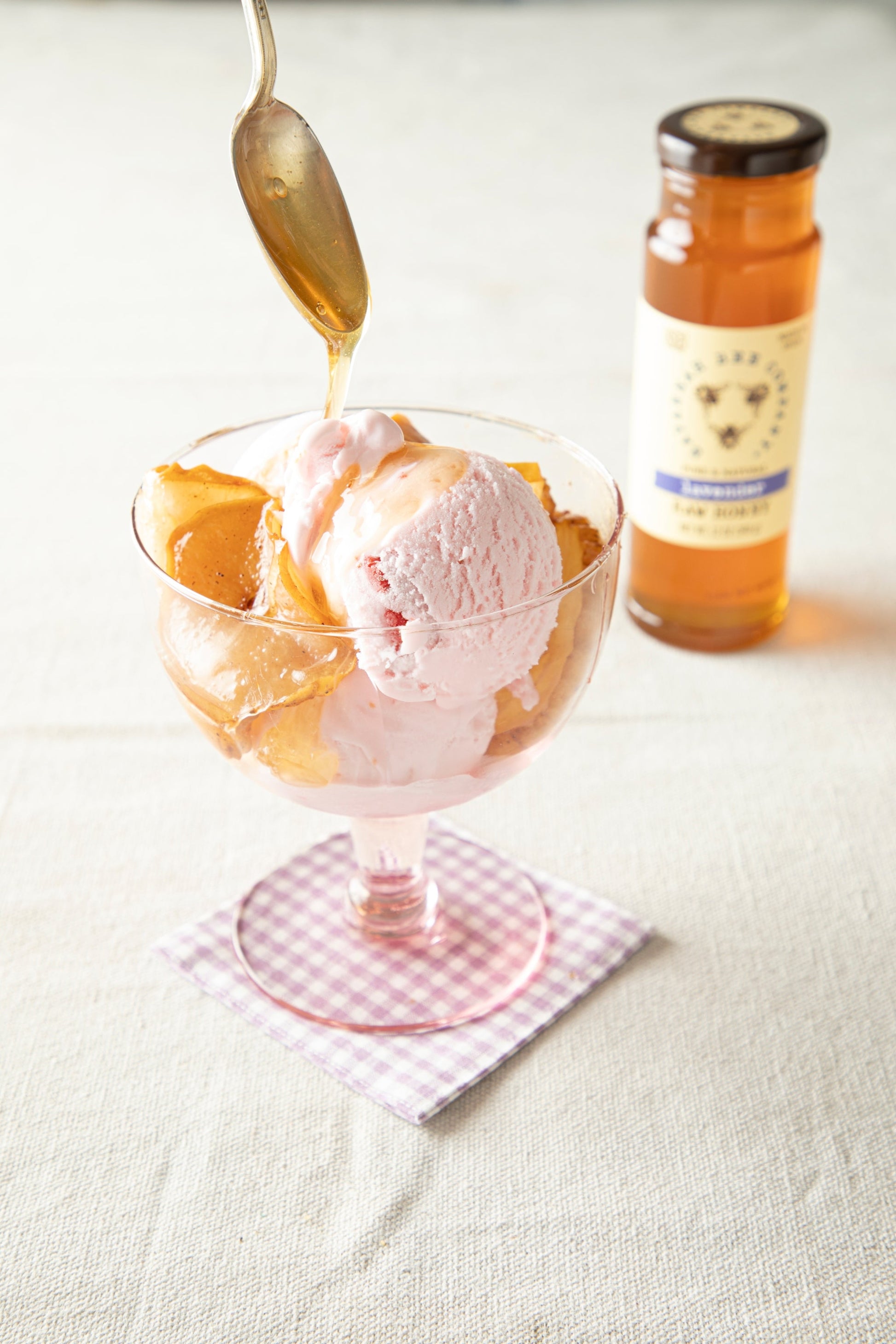 Sauteed Pears and ice dream being drizzled with Lavender Honey.