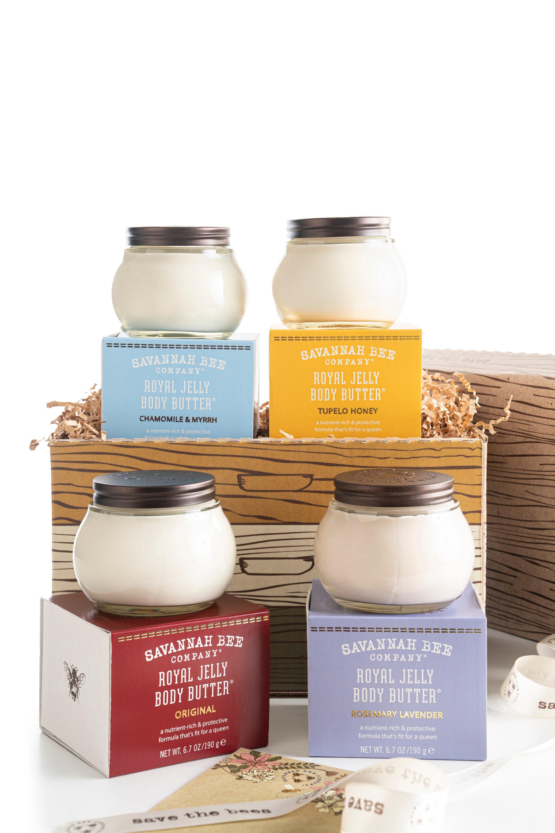 Chamomile and Myrrh Royal Jelly Body Butter, Tupelo Royal Jelly Body Butter, Rosemary Lavender Royal Jelly Body Butter, and Original Royal Jelly Body Butter in a gift box side view.