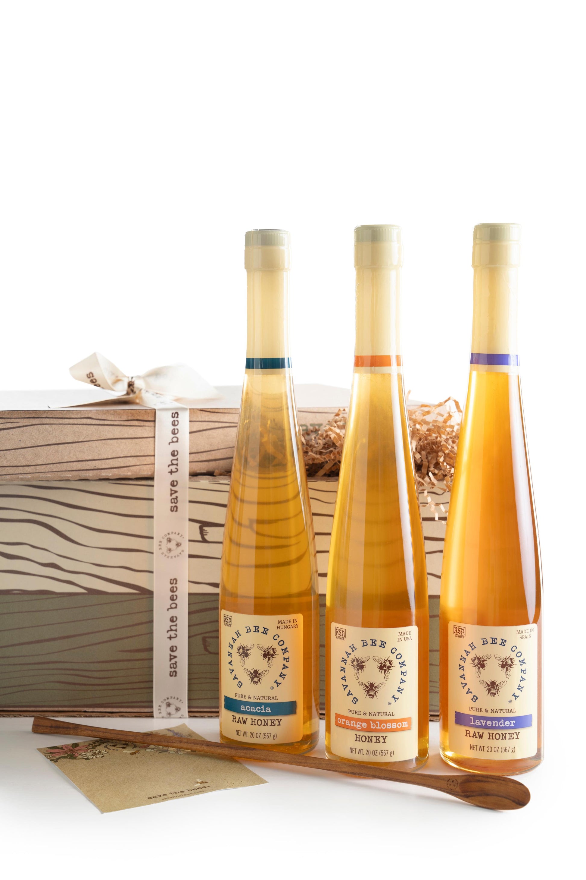 Acacia flute, orange blossom flute, and lavender standing in front of a save the bees gift box with a flute spoon