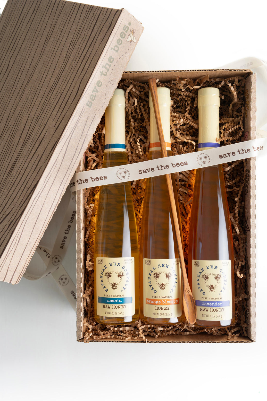 Acacia flute, orange blossom flute, and lavender flute in a save the bees gift box with a flute spoon