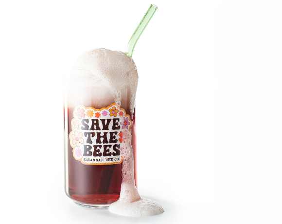 Save the bee can glass with floral pinks, ornage and brown colors. 