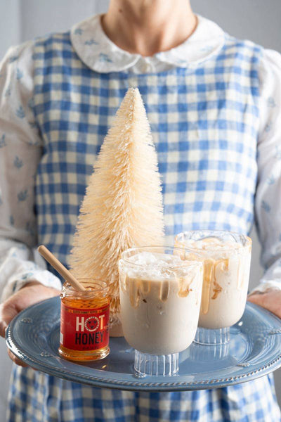 White Russian cocktails on a tray with little white tree.